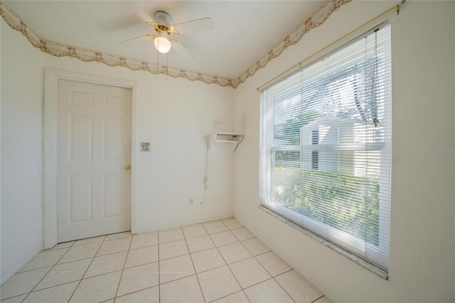 spare room featuring ceiling fan and light tile patterned floors