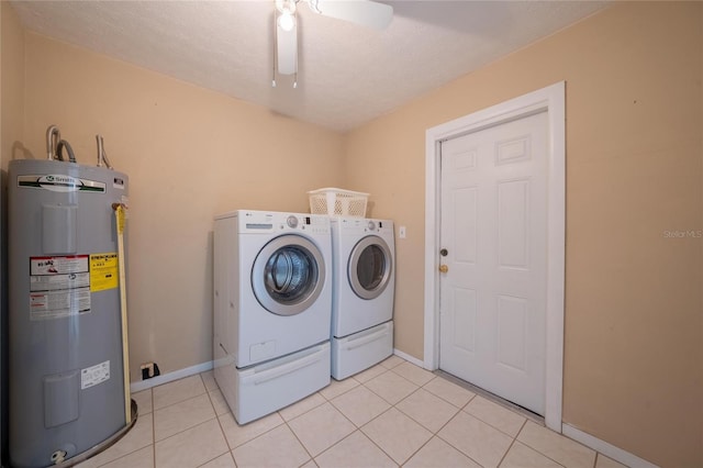 washroom with separate washer and dryer, water heater, light tile patterned floors, and a textured ceiling