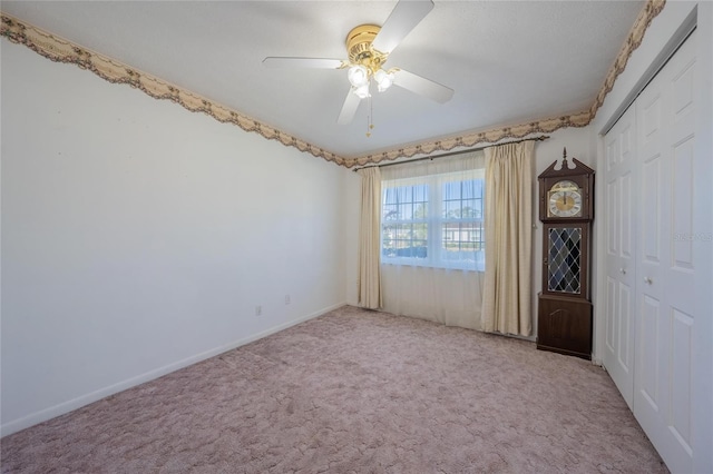 empty room with light carpet and ceiling fan