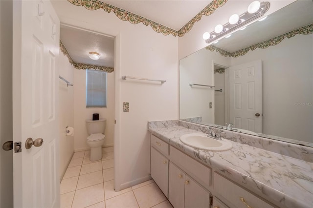 bathroom with tile patterned flooring, vanity, and toilet