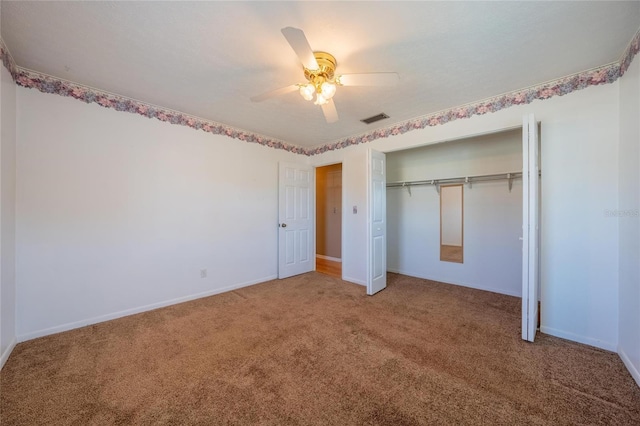 unfurnished bedroom featuring carpet, a closet, and ceiling fan