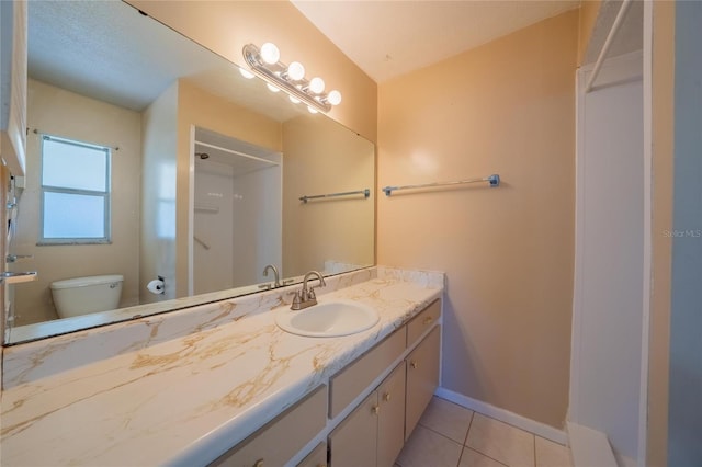 bathroom with tile patterned flooring, a shower, vanity, and toilet