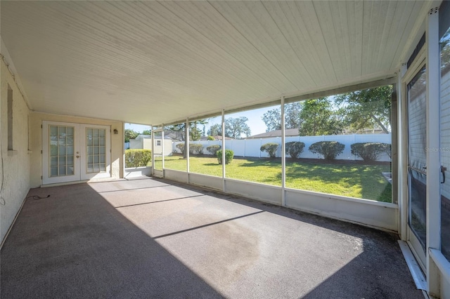 unfurnished sunroom with french doors