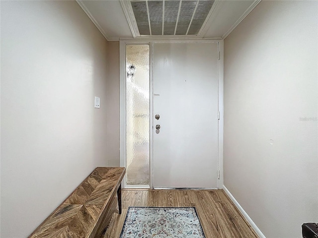 doorway to outside featuring wood-type flooring and ornamental molding