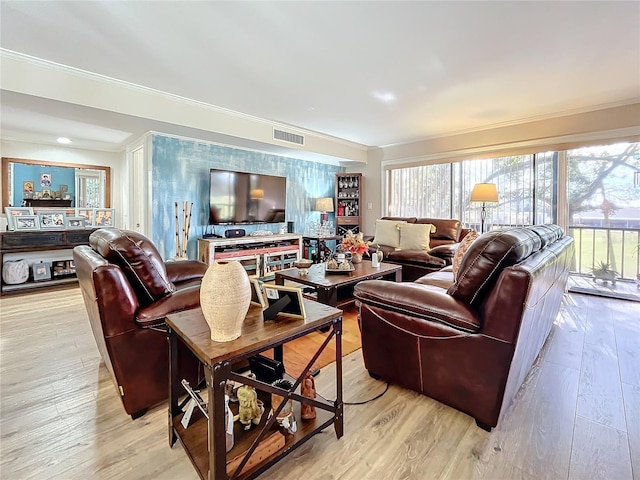 living room with light hardwood / wood-style flooring and ornamental molding