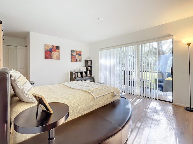 bedroom with access to outside and light hardwood / wood-style floors