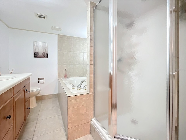 full bathroom with tile patterned floors, separate shower and tub, vanity, and toilet