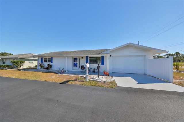 single story home featuring covered porch and a garage