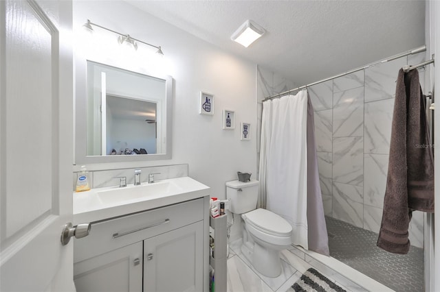 bathroom featuring vanity, curtained shower, toilet, and a textured ceiling