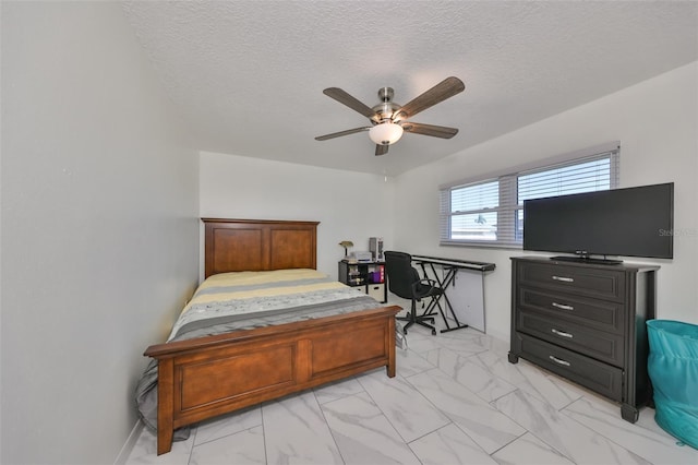 bedroom with ceiling fan and a textured ceiling