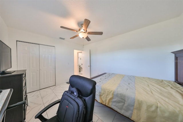 bedroom with ceiling fan and a closet