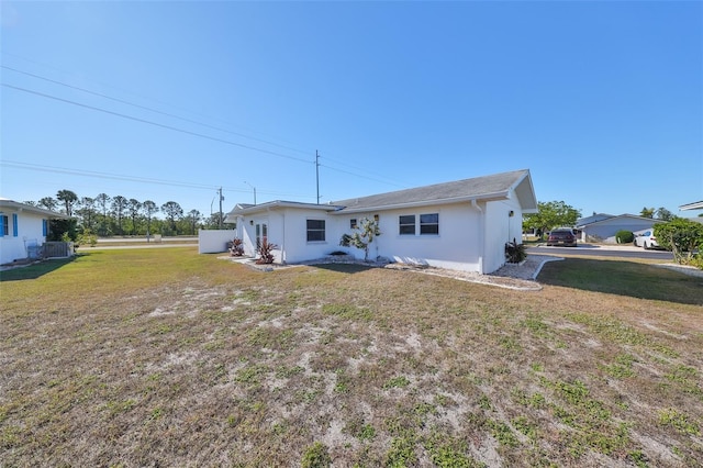 rear view of property with a lawn