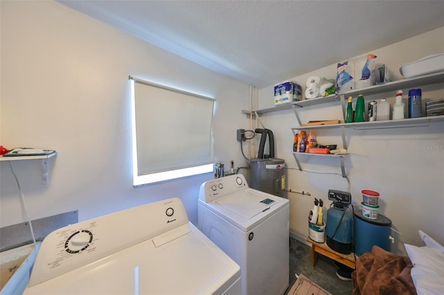 laundry area with electric water heater and independent washer and dryer