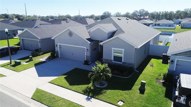 view of front of property featuring a front lawn and a garage