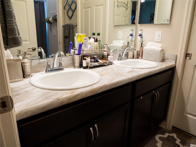 bathroom with hardwood / wood-style floors and vanity