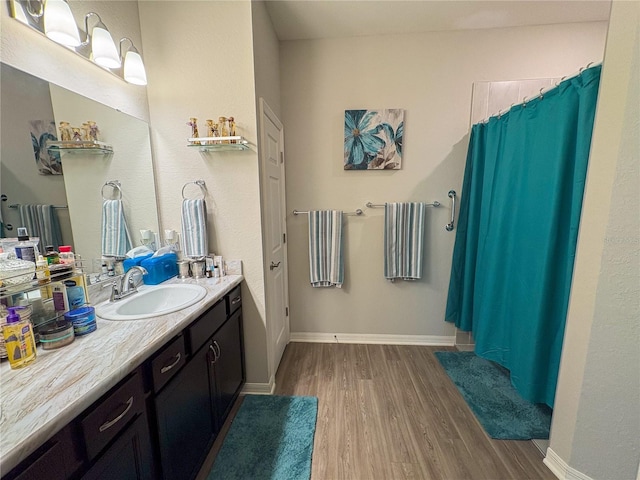 bathroom featuring a shower with curtain, vanity, and wood-type flooring