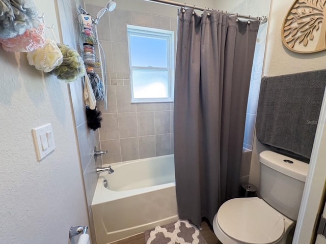 bathroom featuring toilet and shower / bathtub combination with curtain