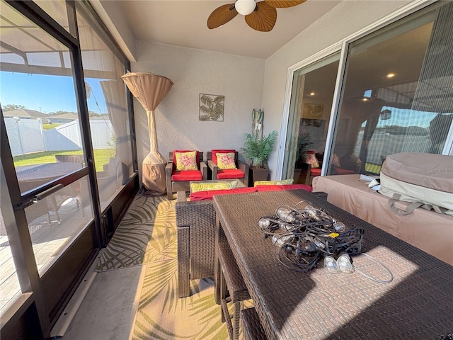 sunroom featuring ceiling fan and a healthy amount of sunlight