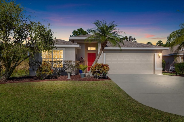 view of front of home with a yard and a garage