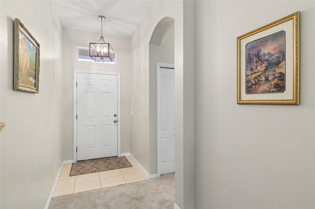 entrance foyer with a notable chandelier and light tile patterned flooring