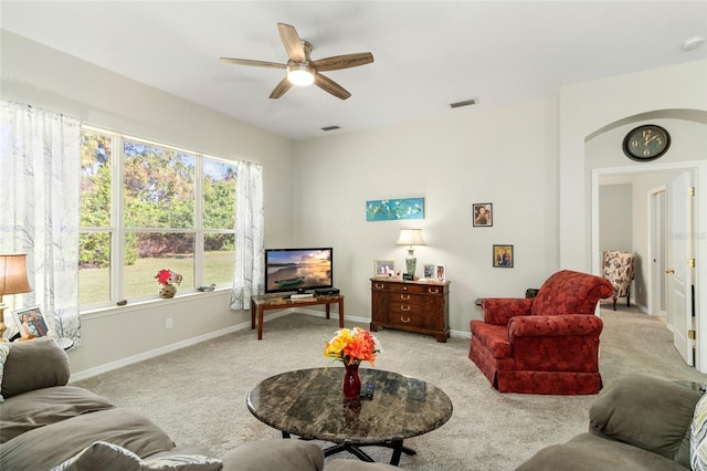 living room with ceiling fan and light colored carpet