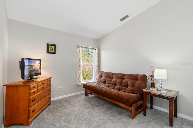 living area with light carpet and vaulted ceiling