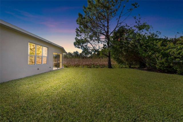 view of yard at dusk