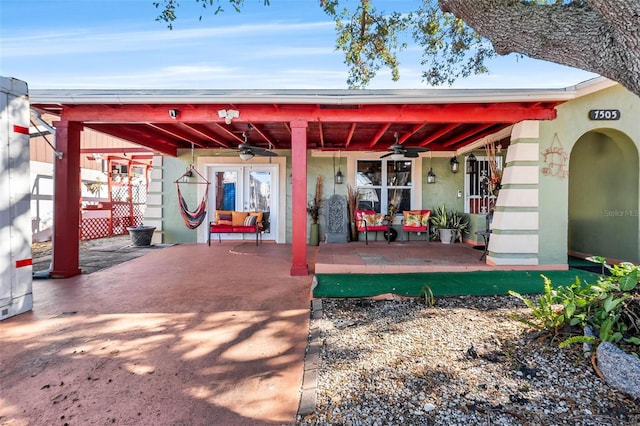 back of property featuring ceiling fan and a patio area