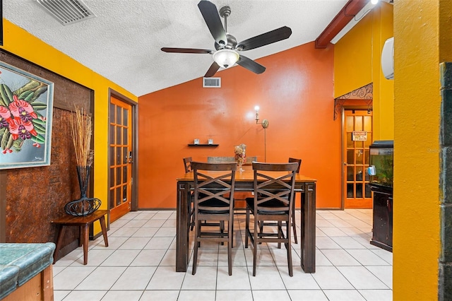 dining area featuring a textured ceiling, vaulted ceiling with beams, light tile patterned floors, and ceiling fan