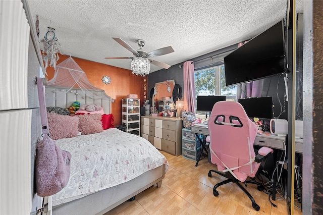 bedroom with ceiling fan and a textured ceiling