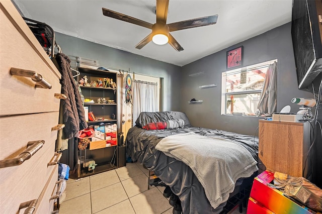 bedroom with ceiling fan and light tile patterned floors