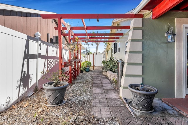 view of patio / terrace featuring a pergola and a shed