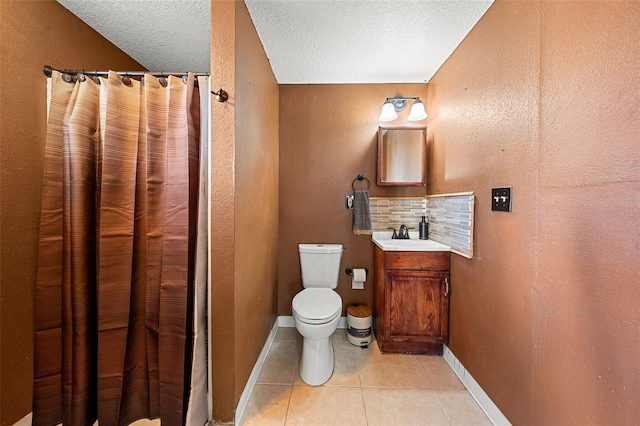 bathroom with backsplash, tile patterned floors, vanity, a textured ceiling, and toilet