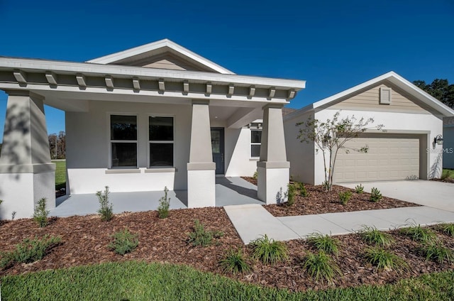 view of front of property with covered porch and a garage