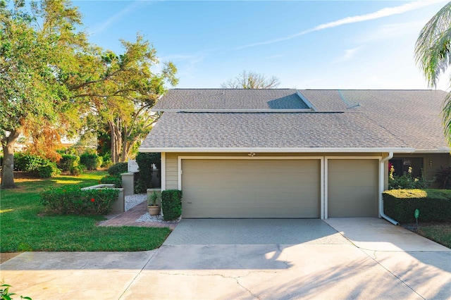 3401 Avenida Madera Unit B, Bradenton, FL 34210 - view of front of home with driveway, a shingled roof, a front lawn, and an attached garage
