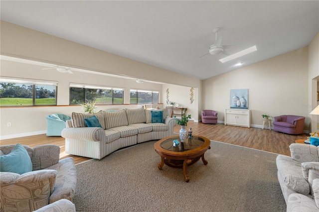 3401 Avenida Madera Unit B, Bradenton, FL 34210 - living area with ceiling fan, wood finished floors, lofted ceiling, baseboards, and a skylight