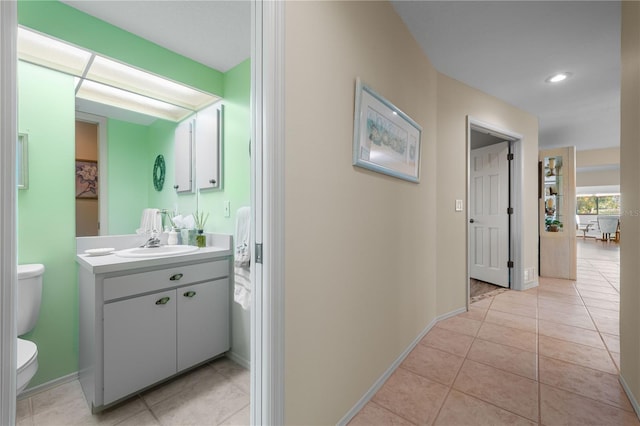 bathroom featuring tile patterned floors, vanity, and toilet