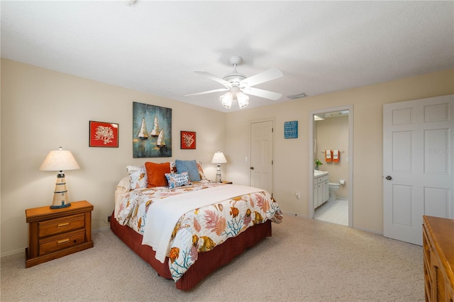 3401 Avenida Madera Unit B, Bradenton, FL 34210 - bedroom with carpet flooring, baseboards, ensuite bath, and a ceiling fan