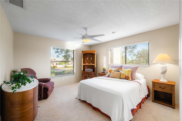 3401 Avenida Madera Unit B, Bradenton, FL 34210 - bedroom with light colored carpet, a ceiling fan, a textured ceiling, and baseboards