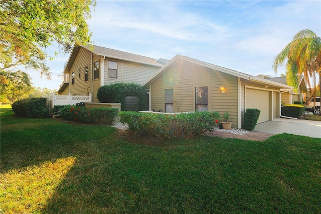 view of front of home featuring a front yard and a garage