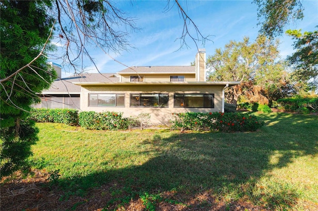 rear view of property featuring a yard