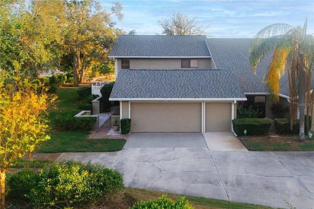 3401 Avenida Madera Unit B, Bradenton, FL 34210 - traditional home with concrete driveway, a shingled roof, a garage, and a front lawn