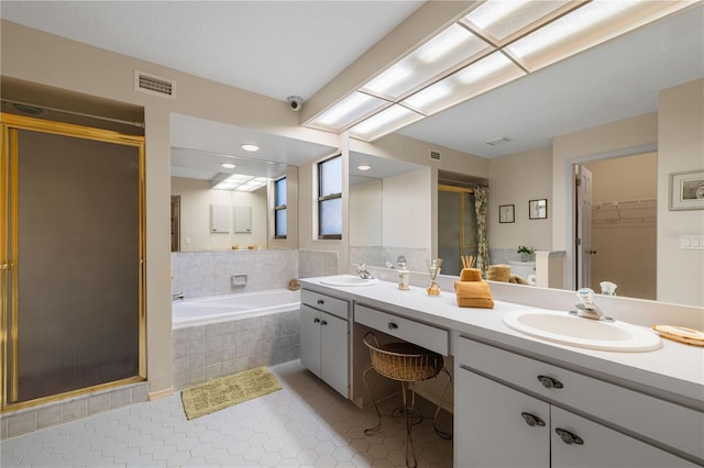 3401 Avenida Madera Unit B, Bradenton, FL 34210 - bathroom featuring a shower stall, double vanity, tile patterned flooring, a walk in closet, and a bath