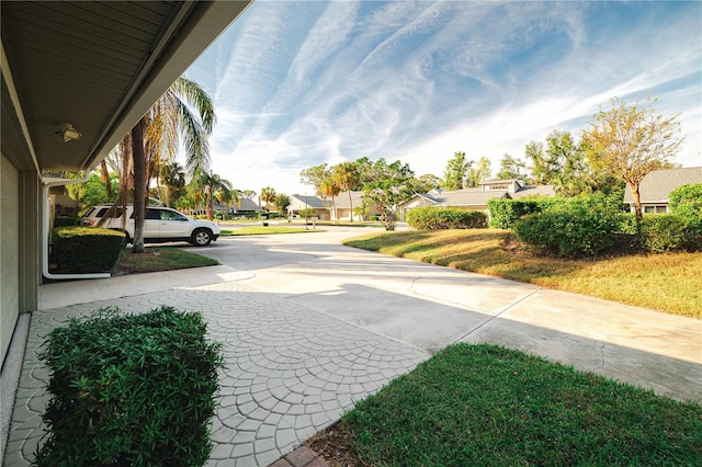 3401 Avenida Madera Unit B, Bradenton, FL 34210 - view of yard featuring a residential view and concrete driveway