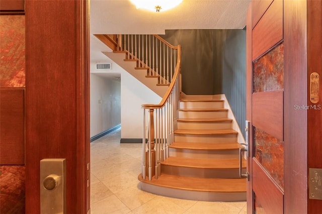 stairs with tile patterned floors