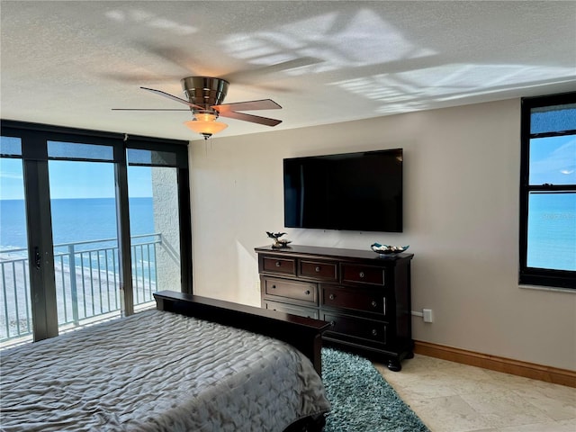 bedroom with ceiling fan, access to exterior, and multiple windows