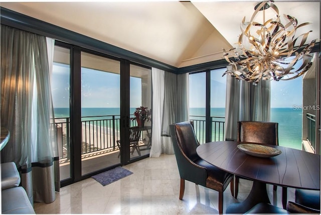 sunroom with a water view, a healthy amount of sunlight, and lofted ceiling