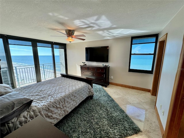 tiled bedroom featuring ceiling fan, a textured ceiling, and access to outside