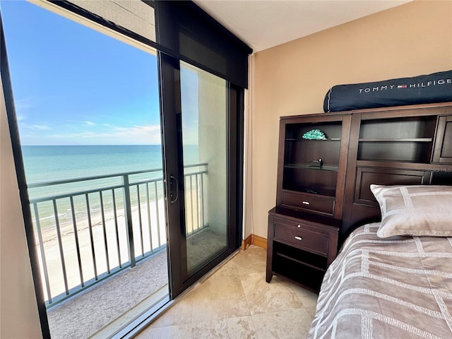 bedroom with a water view and a beach view