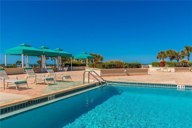 view of swimming pool featuring a patio area and a gazebo